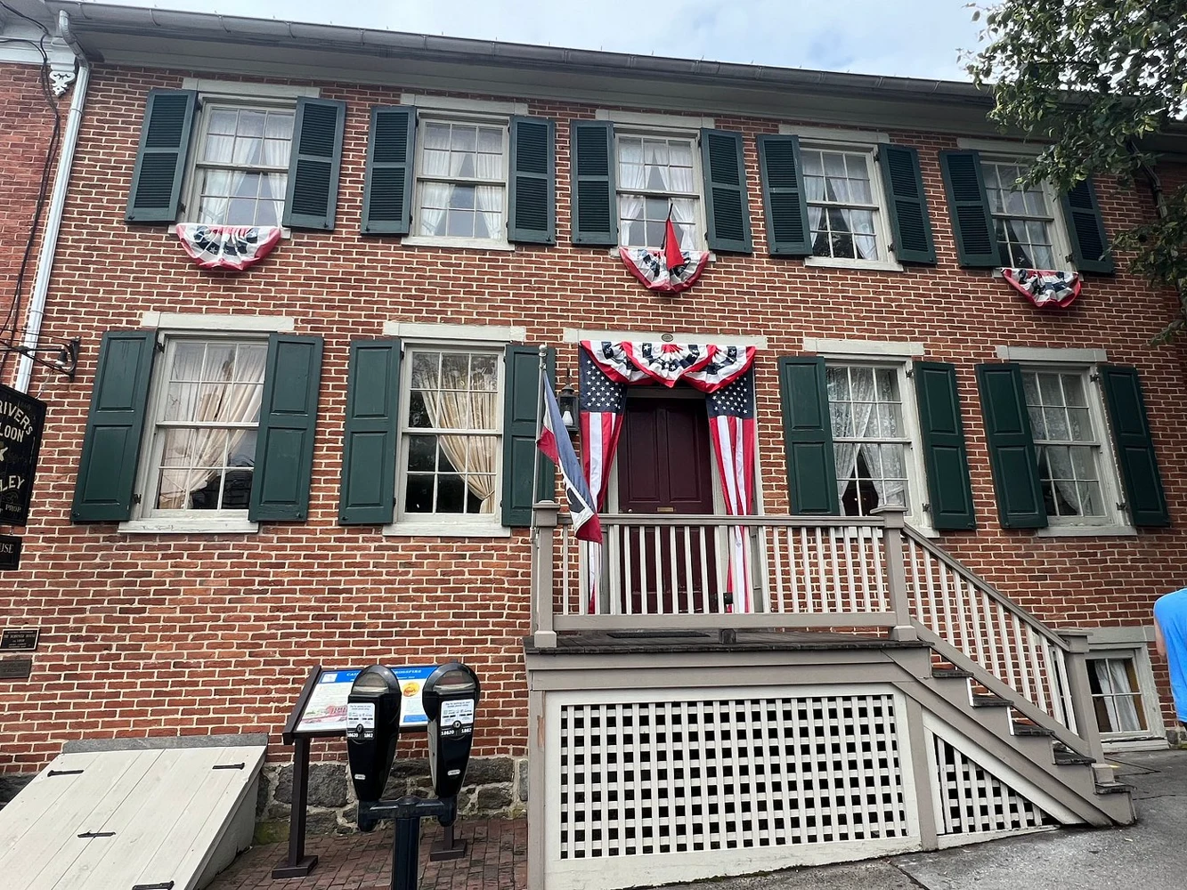 The brick facade and green shutters of the Shriver House Museum